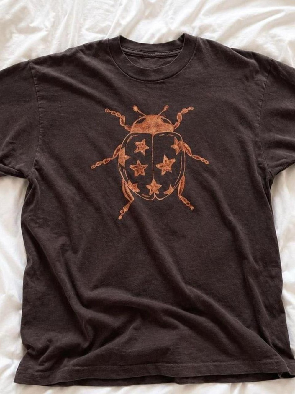 Gildan Black Tee with Orange Star Ladybug Graphic, NK Folk Music Shirt